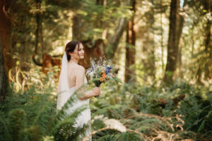 bride in forest with her kelowna wedding hair and makeup