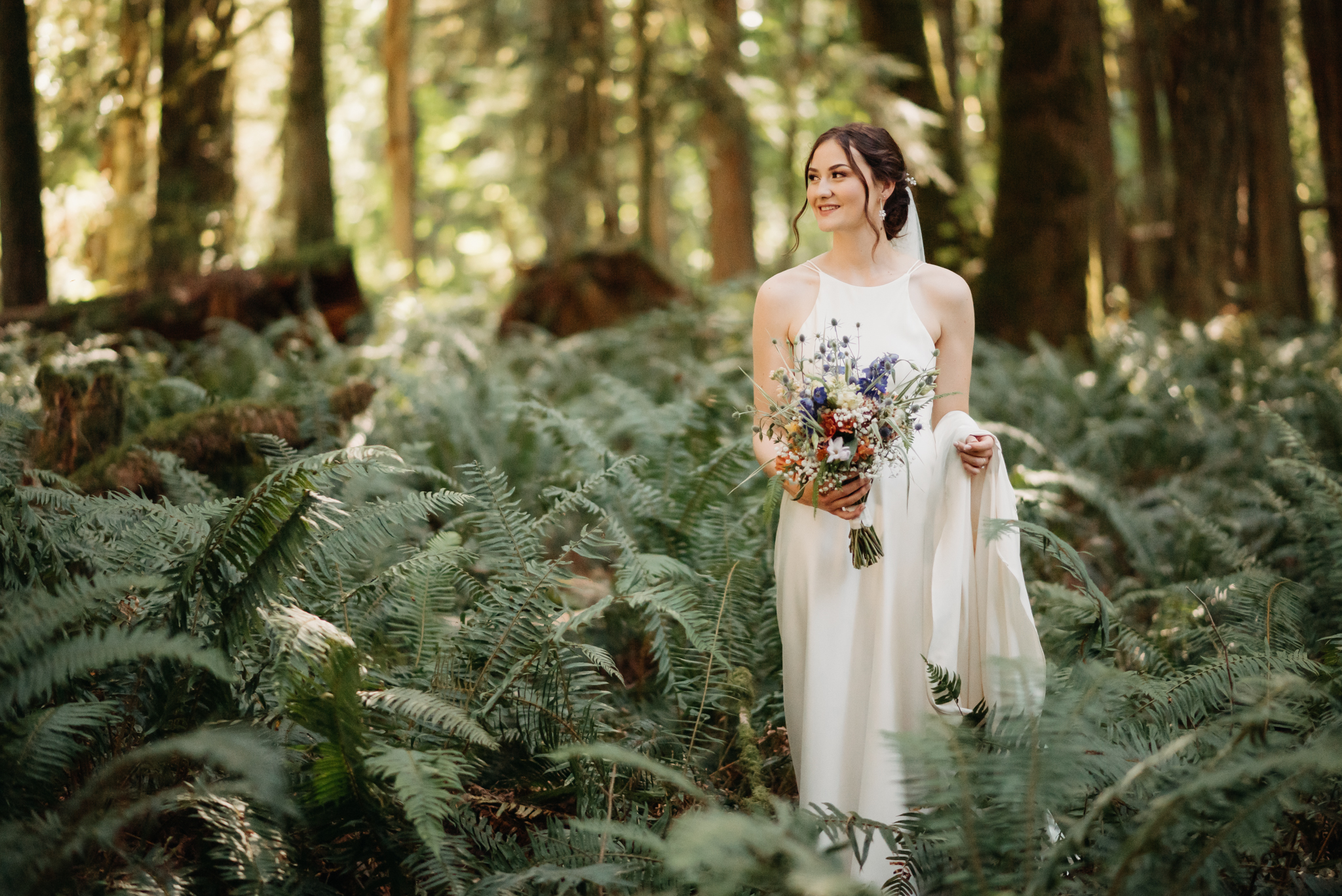 bride holding her bouquet in the forest