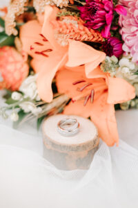 rings with flowers at wedding