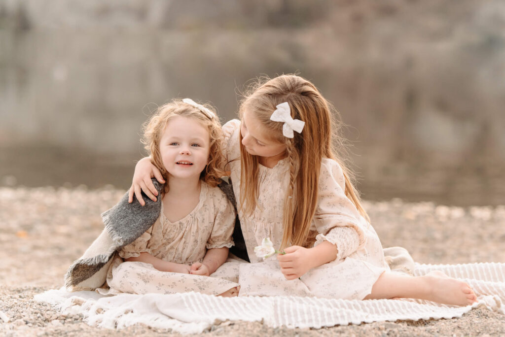 sisters cuddling in a penticton family photography session