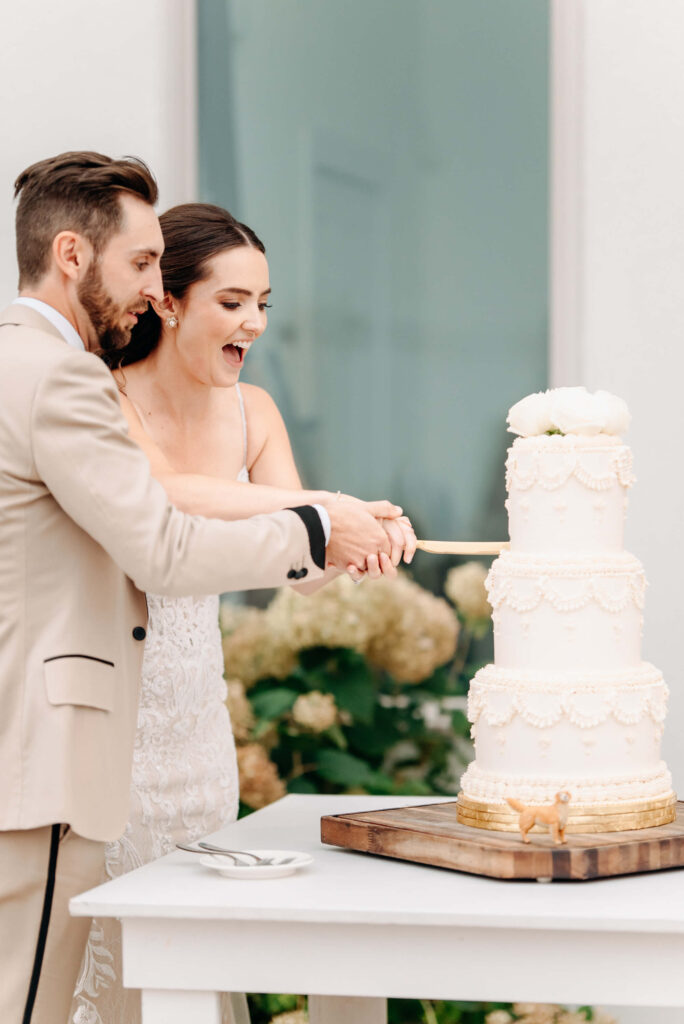 couple cut into their wedding cake
