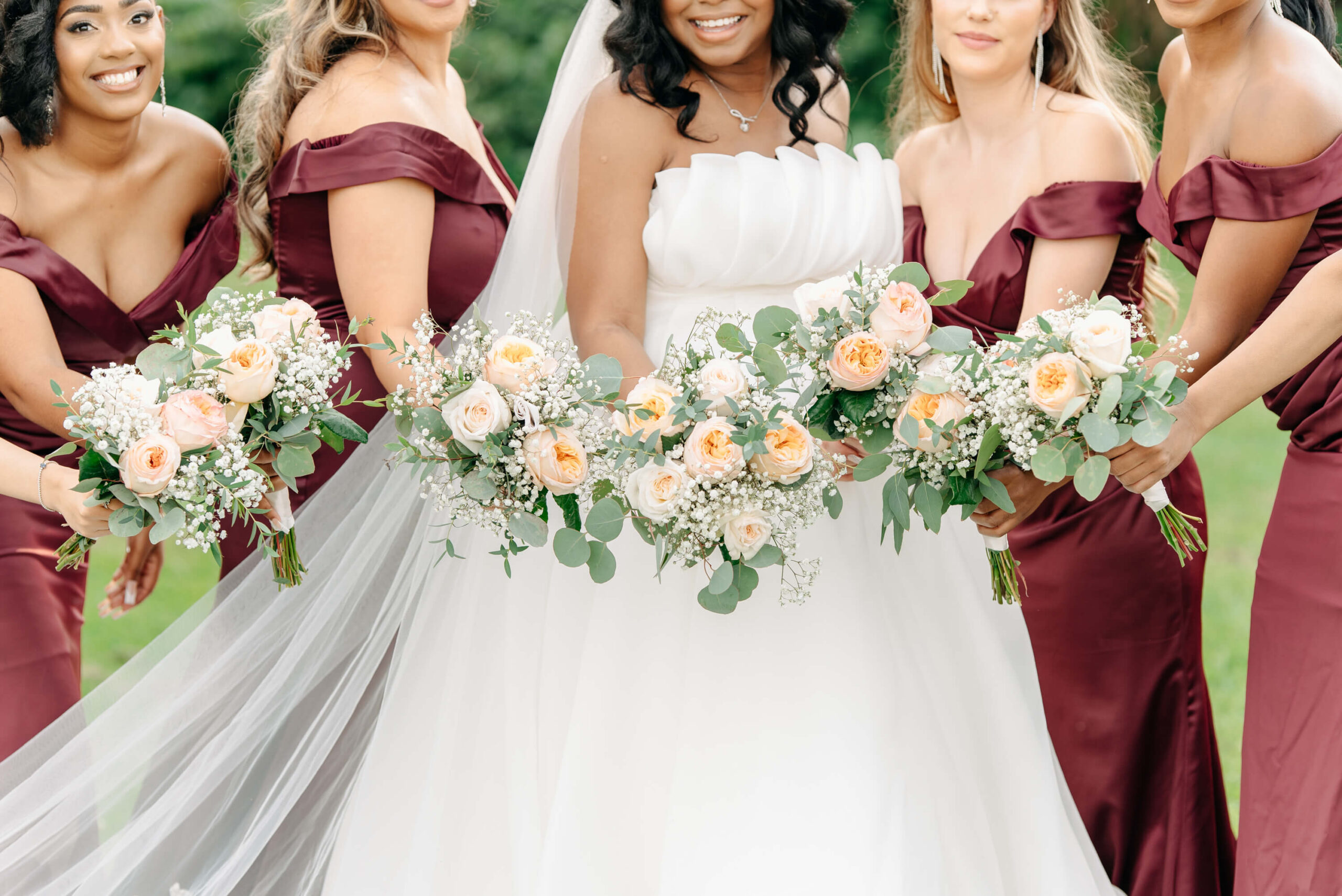 bride and bridesmaids hold their beautiful bouquets on their wedding day